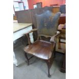 A late Victorian mahogany and brown leather desk chair