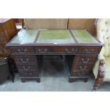 A mahogany and green leather topped pedestal desk