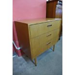 A teak chest of drawers