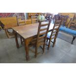 A Nigel Griffiths carved oak dining table and four chairs