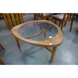 A Nathan teak and glass topped triangular coffee table