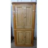 A George III style pine freestanding corner cupboard