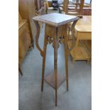 An Arts and Crafts oak jardiniere stand