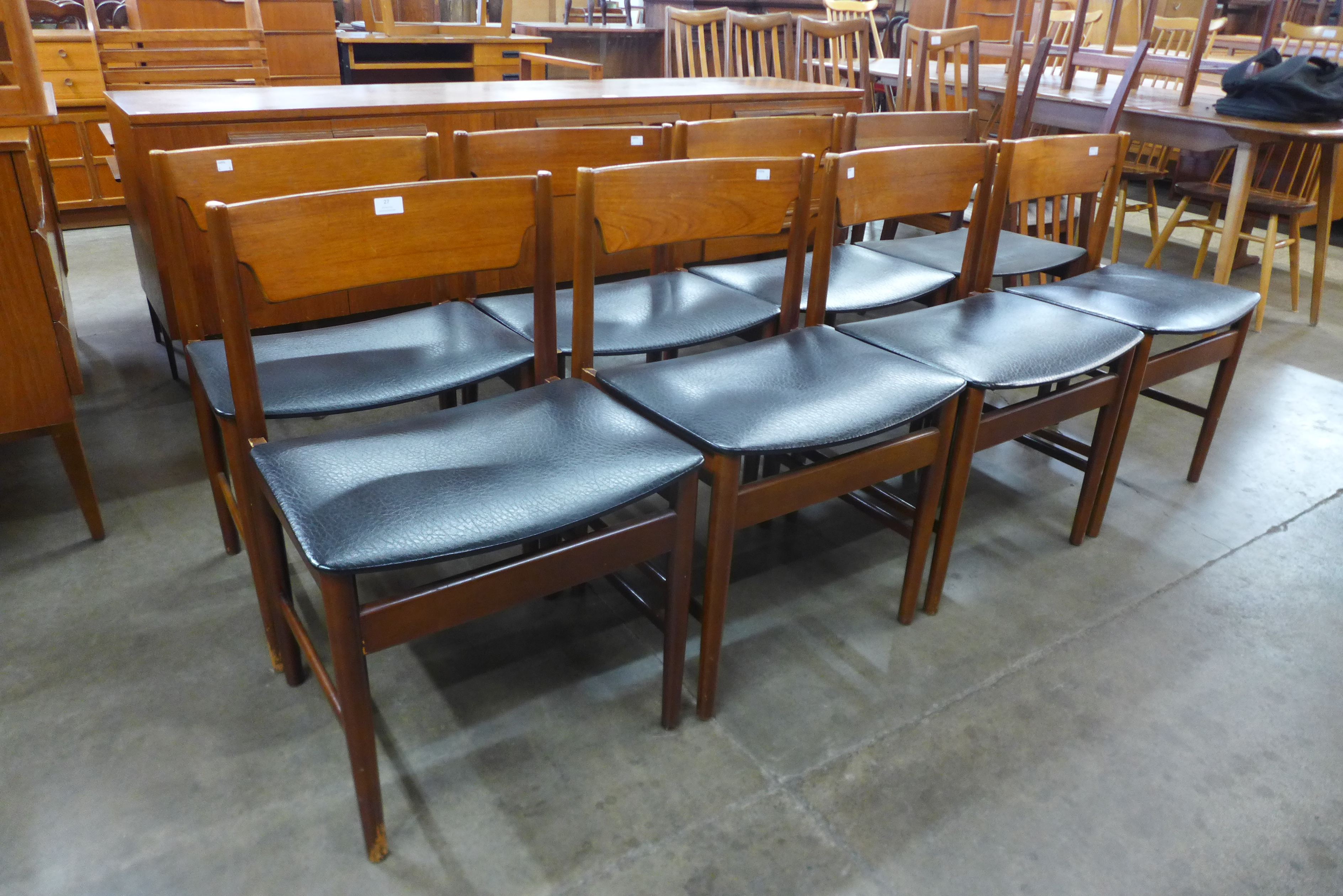 A set of eight teak dining chairs