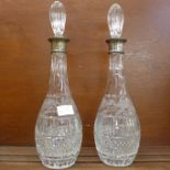 A pair of silver rimmed crystal decanters