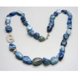 A large silver and blue agate necklace