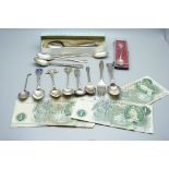 Seven £1 banknotes, assorted silver teaspoons, coffee spoons and souvenir spoons, 275g