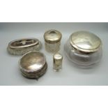 A silver lidded pot, silver topped hair tidy, a silver and tortoiseshell topped box, a silver