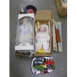 A box of modern dolls, a tin of die-cast vehicles, Adam Faith 7" singles and a case of Elvis Presley