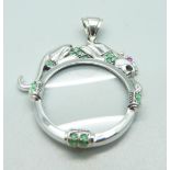 An Art Deco silver wild cat emerald set magnifying glass/pendant