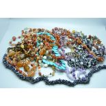 A collection of gemstone necklaces, including amethyst, turquoise, agate, etc.