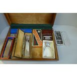 A case containing Rolls razors and three harmonicas, includes Hohner 64 Chromonica