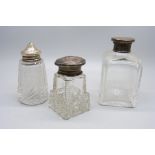 A hallmarked silver topped salt pot and two silver topped scent bottles, (one is hallmarked, the