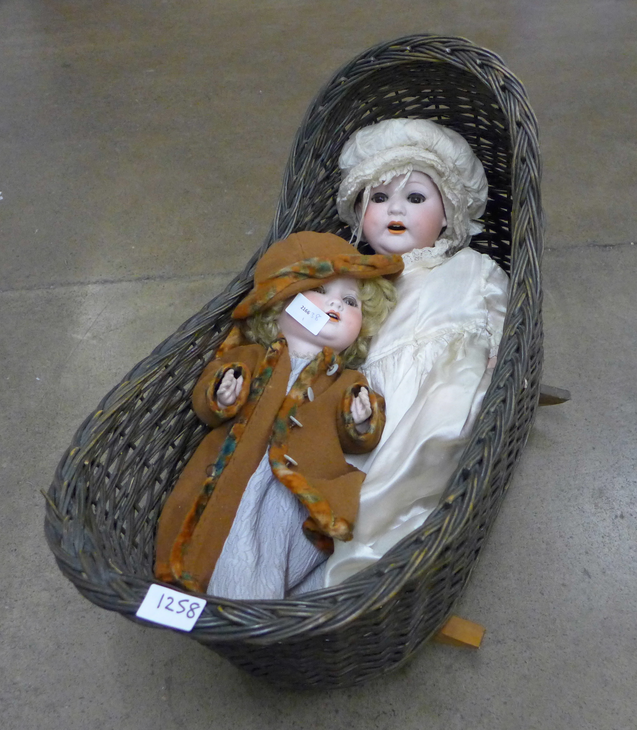 Two Edwardian dolls and a basket **PLEASE NOTE THIS LOT IS NOT ELIGIBLE FOR POSTING AND PACKING**