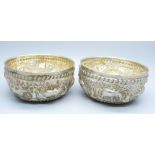 A pair of African white metal embossed bowls, decorated with African wild animals, 144g