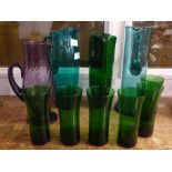 Four coloured glass jugs and six drinking glasses