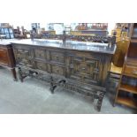 An early 20th century Jacobean Revival carved oak geometric moulded barleytwist sideboard