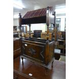 An early 20th Century oak bookstand, with fifteen books