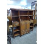 A Victorian walnut breakfront open bookcase, manner of James Schoolbred