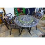 A cast alloy garden table and two chairs