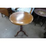 A Victorian mahogany circular tripod wine table