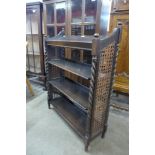 An early 20th Century oak bergere open bookcase