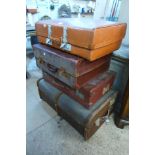 A steamer trunk and three suitcases