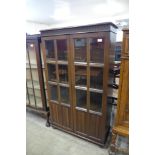 A carved oak linenfold two door bookcase