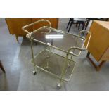 An Italian brass and glass two tier cocktail trolley