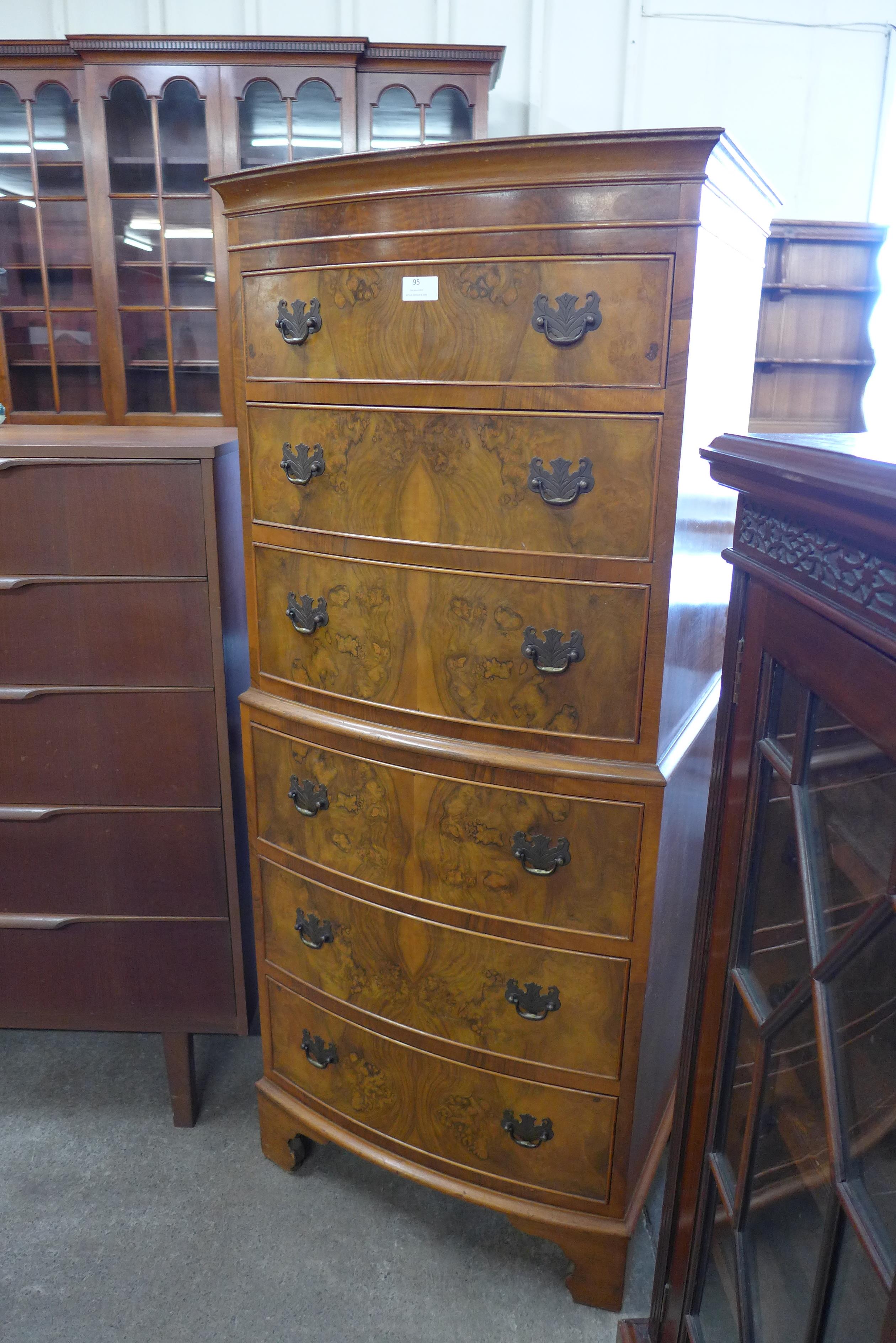 A George III style walnut bow front chest of drawes