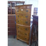 A George III style walnut bow front chest of drawes