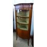 An Edward VII inlaid mahogany serpentine corner cabinet