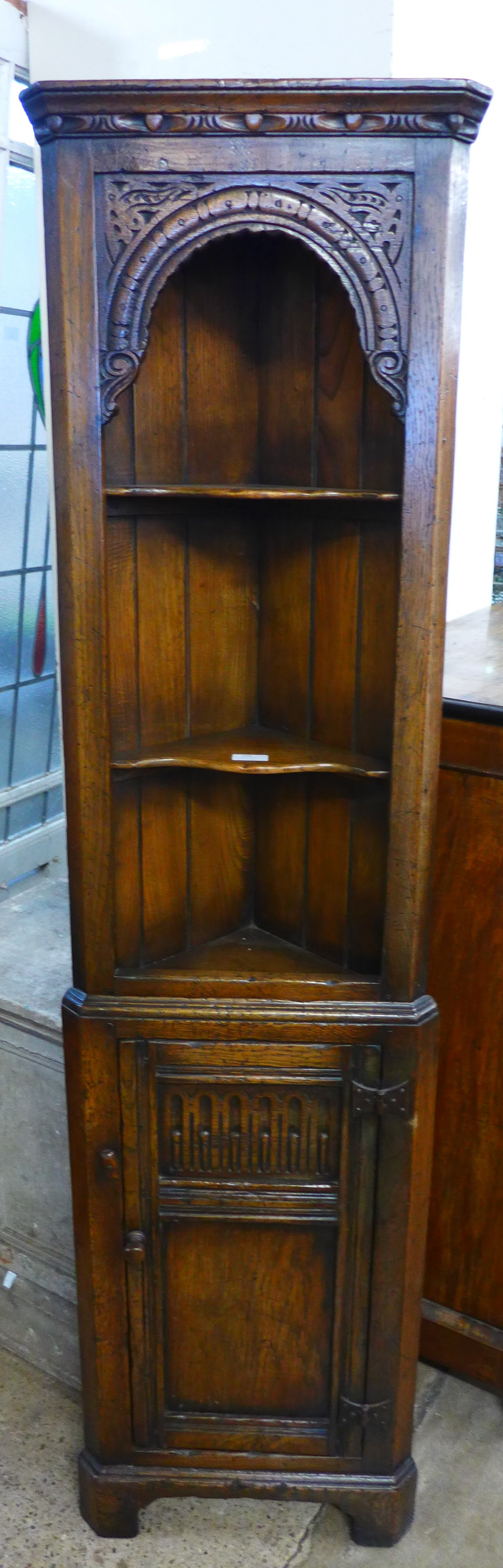 A 17th Century style carved Ipswich oak freestanding corner cabinet