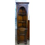 A 17th Century style carved Ipswich oak freestanding corner cabinet