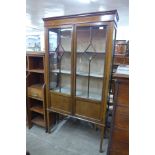 An Edward VII inlaid mahogany two door display cabinet