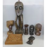 A collection of African carvings including figures, mask and busts