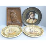 An Arts and Crafts style carved wooden plaque, two Portuguese plates and a charger with portrait