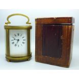 A French carriage clock, oval case with travel case and key