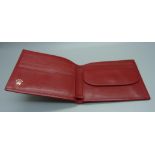 A red leather Rolex wallet