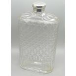 A silver topped glass flask