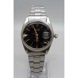 A late 1950's/early 1960's Rolex Oysterdate wristwatch, black dial with gold hour markers and hands,