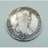 An 8 Reals piece of eight coin, 1823, a/f, drilled