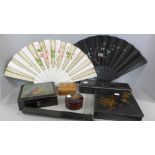 Three oriental fans and a collection of lacquered boxes