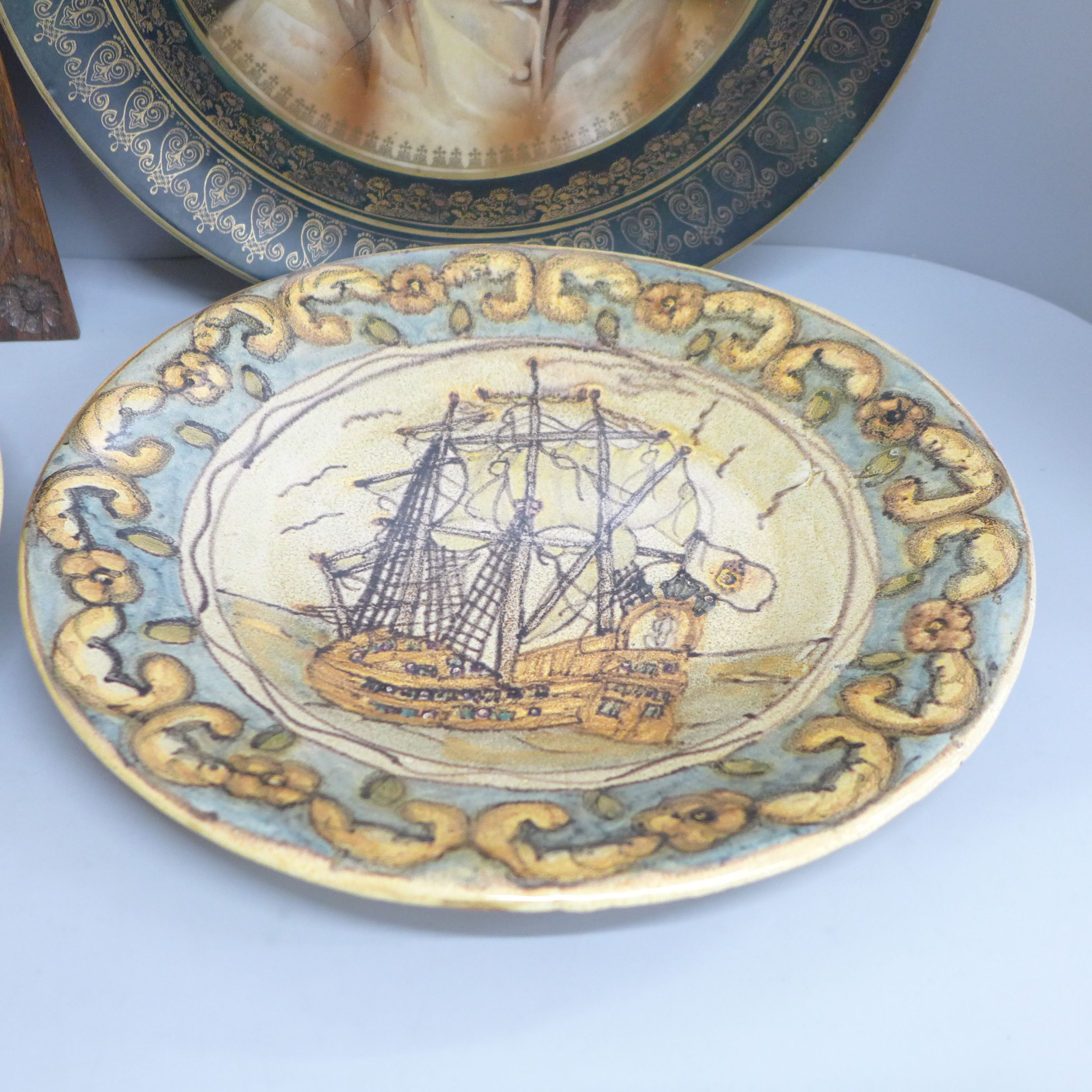 An Arts and Crafts style carved wooden plaque, two Portuguese plates and a charger with portrait - Image 2 of 4