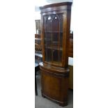 A burr walnut freestanding corner cabinet