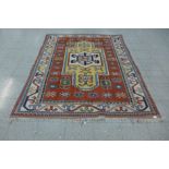 An eastern terracotta ground rug, 209 x 176cms