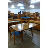 A Morris of Glasgow walnut dining table and four chairs