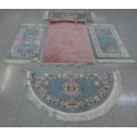 Four small Chinese blue ground rugs and one other