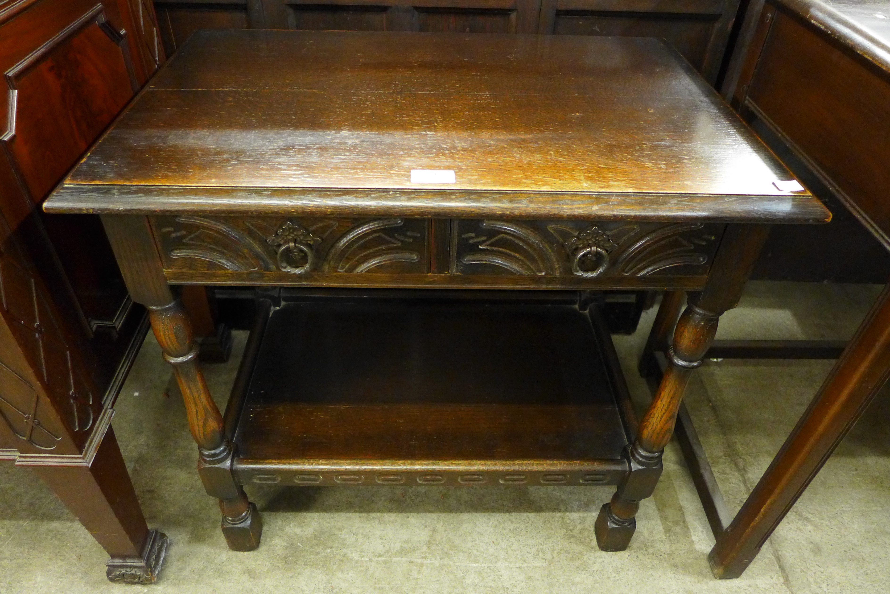 A carved oak single drawer hall table