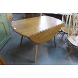 An Ercol Golden Dawn drop-leaf dining table